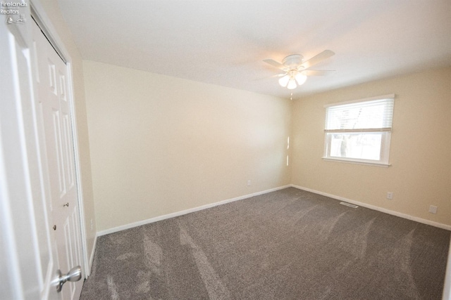 spare room with ceiling fan and carpet flooring