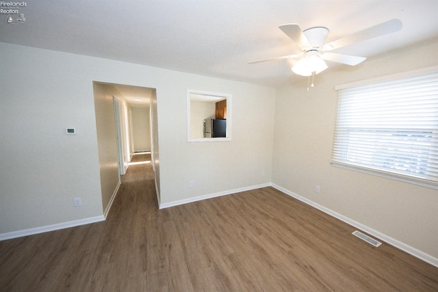 spare room with ceiling fan and dark hardwood / wood-style floors