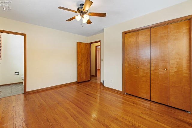 unfurnished bedroom with light wood-type flooring, ceiling fan, and ensuite bath