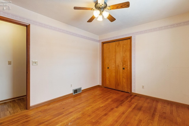 unfurnished room featuring ceiling fan and wood-type flooring