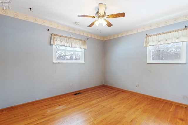 unfurnished room featuring ceiling fan and hardwood / wood-style flooring