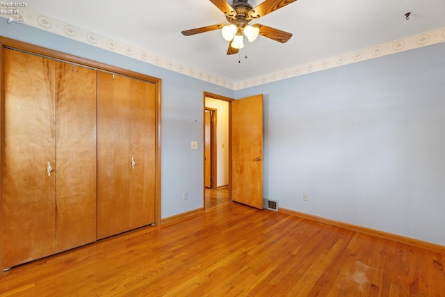 unfurnished bedroom with ceiling fan, light hardwood / wood-style floors, and a closet