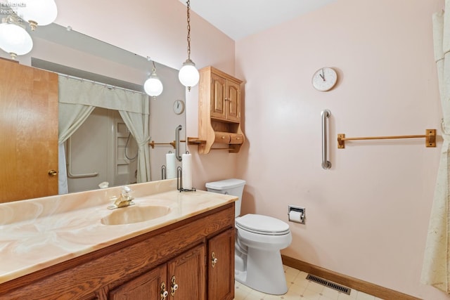 bathroom with toilet and vanity