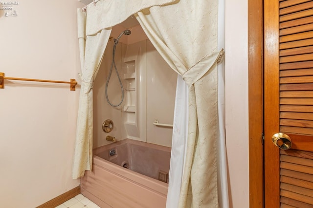 bathroom with shower / bath combo with shower curtain