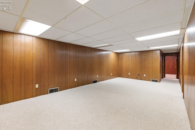 basement featuring carpet and a paneled ceiling