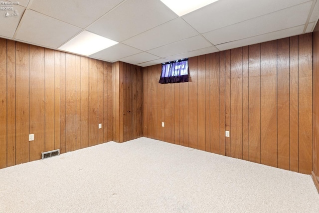 basement with a paneled ceiling