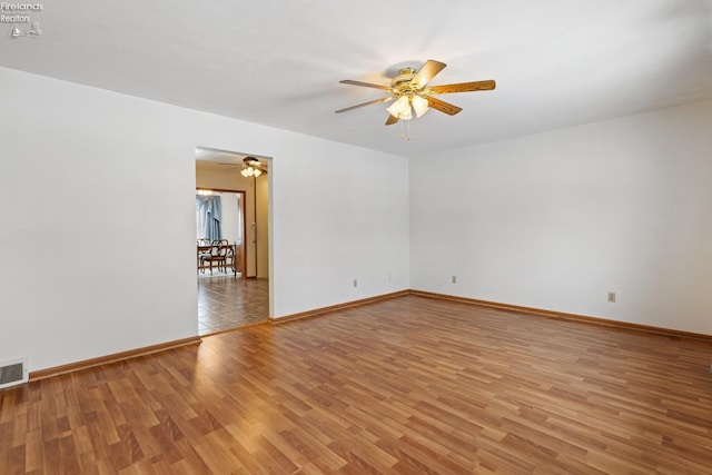 empty room featuring ceiling fan and light hardwood / wood-style floors