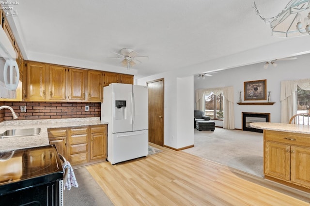 kitchen with ceiling fan, a wealth of natural light, sink, stainless steel electric stove, and white fridge with ice dispenser