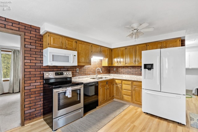 kitchen featuring ceiling fan, white appliances, light wood-type flooring, light stone countertops, and sink