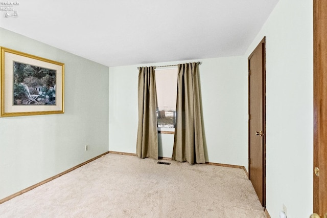 empty room with light colored carpet