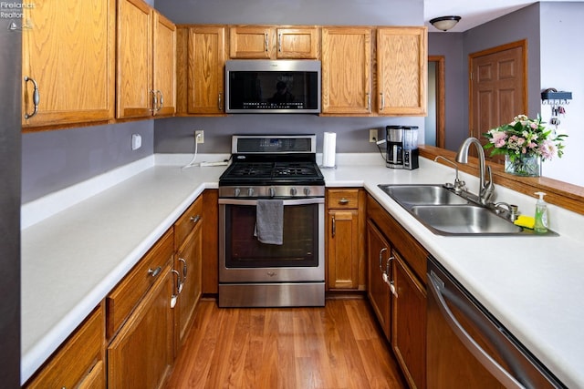 kitchen featuring sink, stainless steel appliances, and light hardwood / wood-style floors