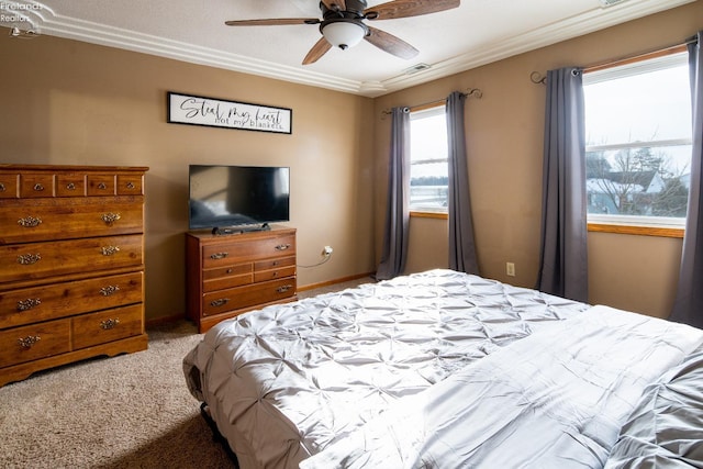 carpeted bedroom with crown molding and ceiling fan