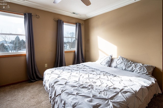 bedroom featuring crown molding, light colored carpet, and ceiling fan