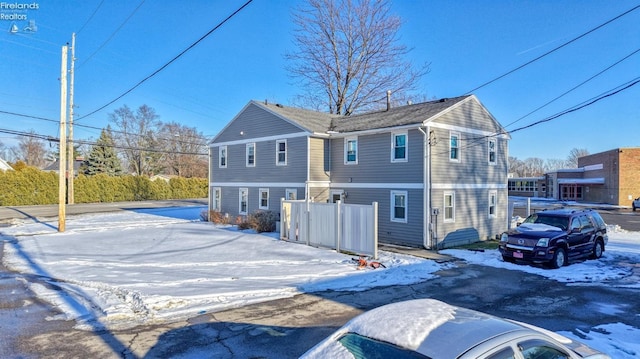 view of snow covered rear of property