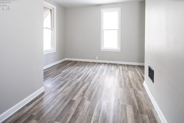 unfurnished room with wood-type flooring