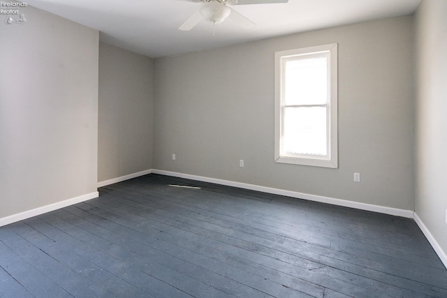 empty room featuring dark wood-type flooring and ceiling fan