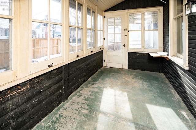 unfurnished sunroom with lofted ceiling