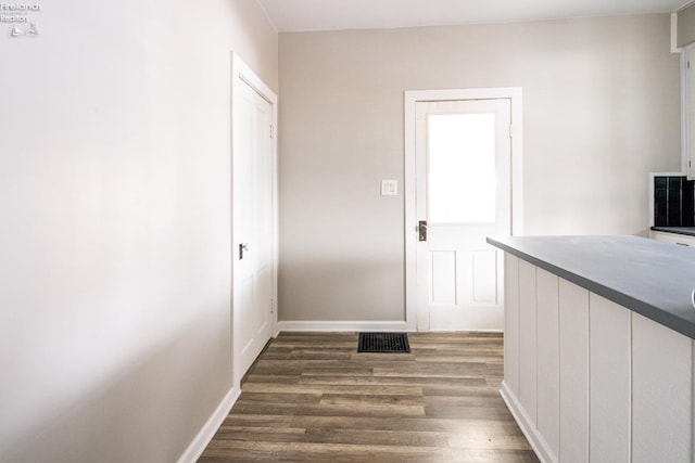 hallway with dark hardwood / wood-style flooring