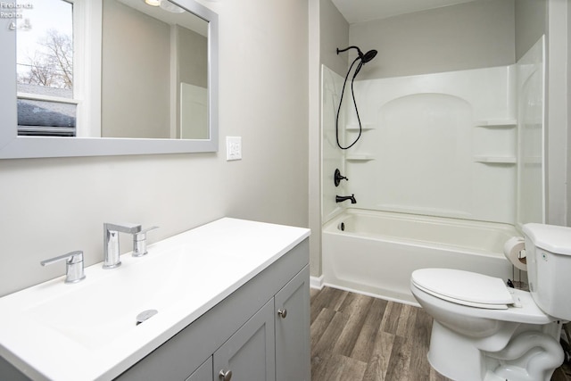 full bathroom with vanity, hardwood / wood-style floors, toilet, and shower / bath combination