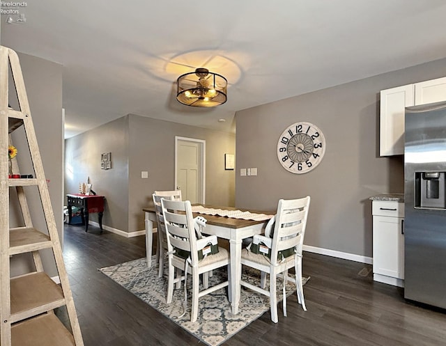 dining room with dark hardwood / wood-style flooring