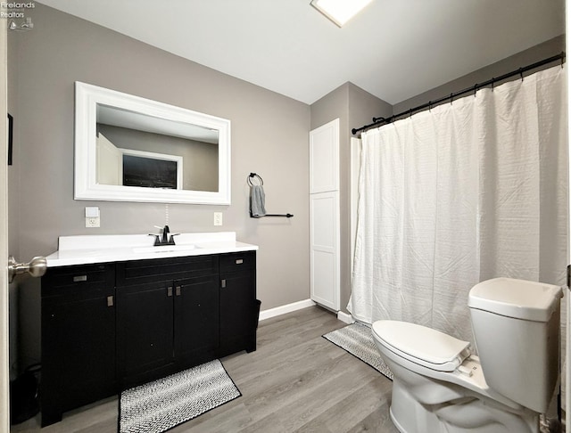 bathroom featuring hardwood / wood-style floors, toilet, and vanity