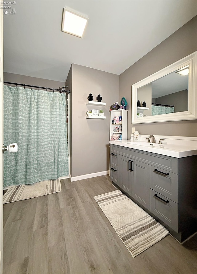 bathroom with vanity, hardwood / wood-style floors, and curtained shower