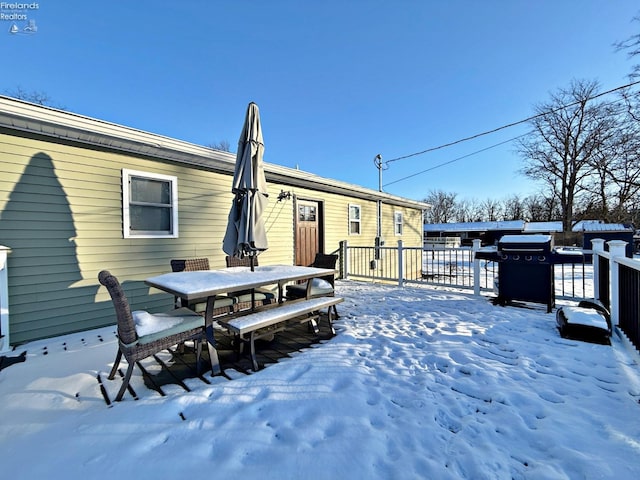 snow covered deck featuring a grill