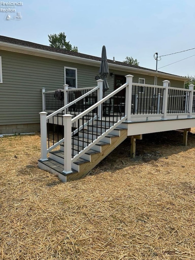 back of house featuring a wooden deck