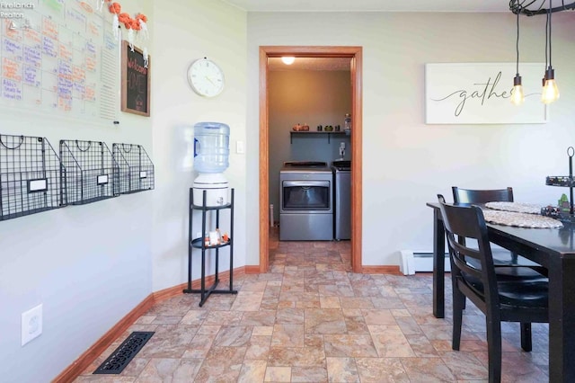 dining room featuring baseboard heating and washer and dryer