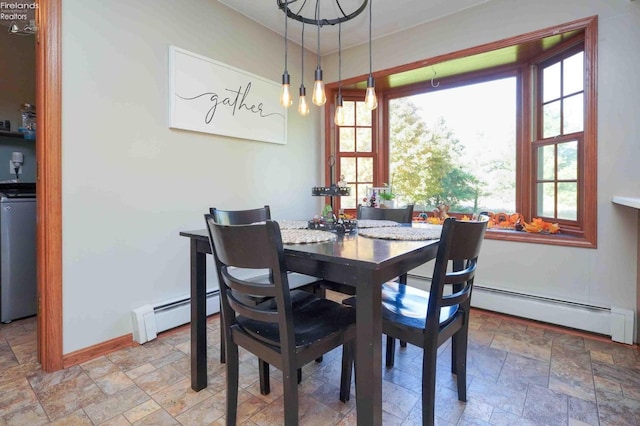 dining space featuring a baseboard heating unit and washer / dryer