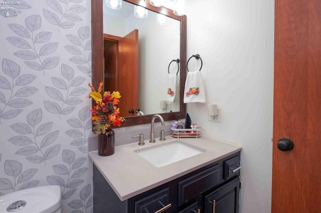 bathroom featuring toilet and vanity