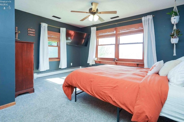 bedroom with baseboard heating, carpet floors, and ceiling fan