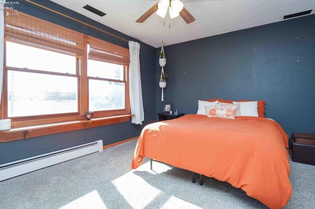 bedroom featuring baseboard heating, carpet flooring, and ceiling fan