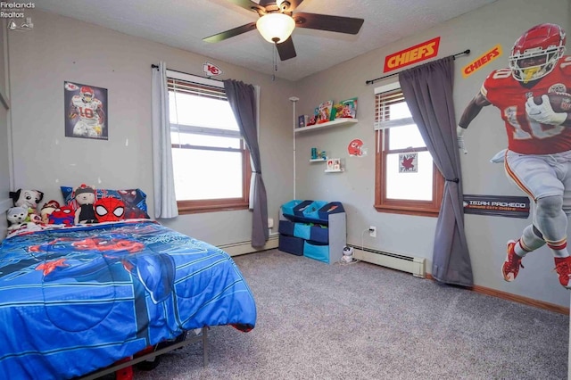 bedroom with carpet, multiple windows, a baseboard heating unit, and ceiling fan