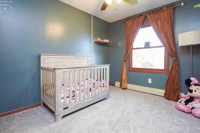 bedroom with carpet, ceiling fan, and a nursery area