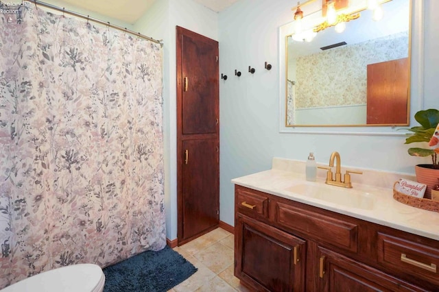 bathroom featuring tile patterned floors, toilet, and vanity