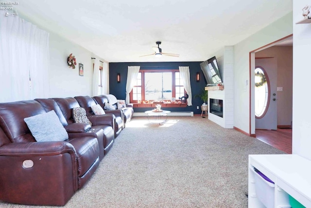 living room with ceiling fan, light colored carpet, and a fireplace