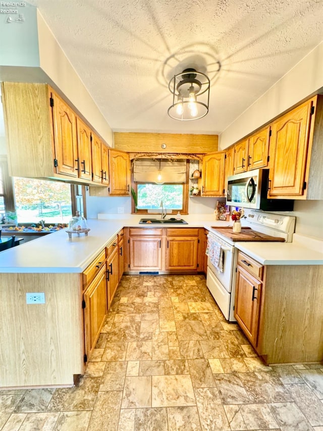 kitchen featuring sink, a textured ceiling, and white electric stove