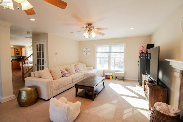 carpeted living room featuring ceiling fan