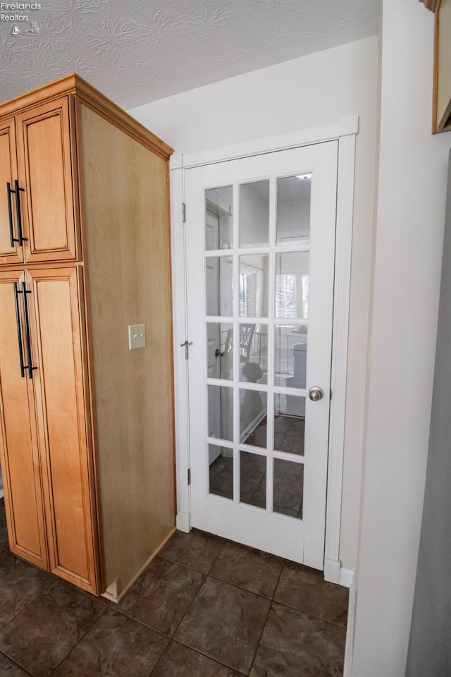 entryway featuring a textured ceiling