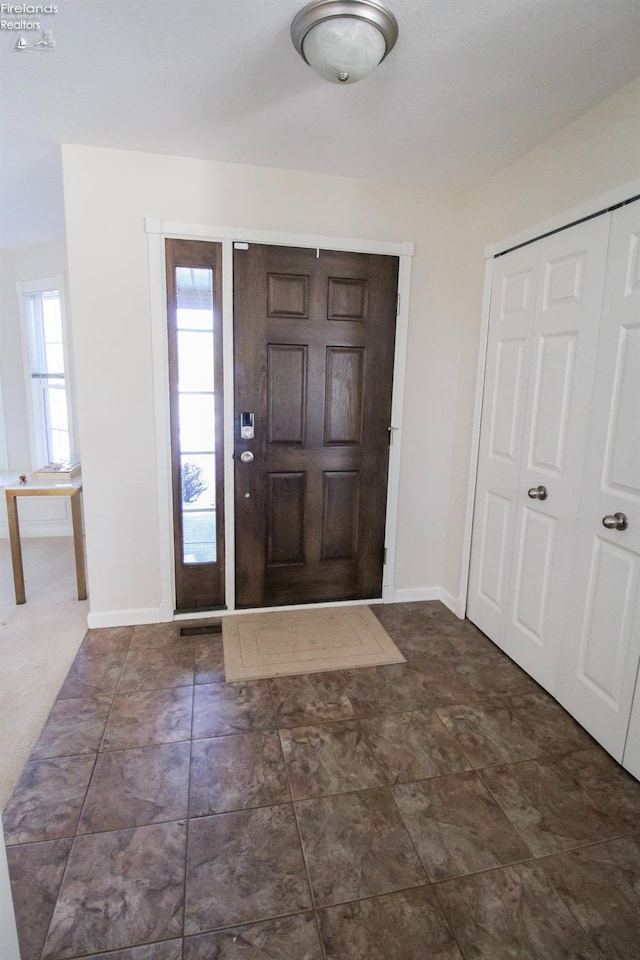 view of carpeted foyer