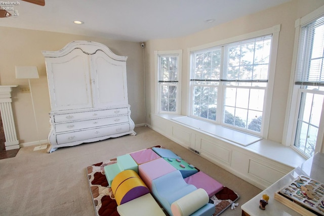 sitting room featuring light carpet