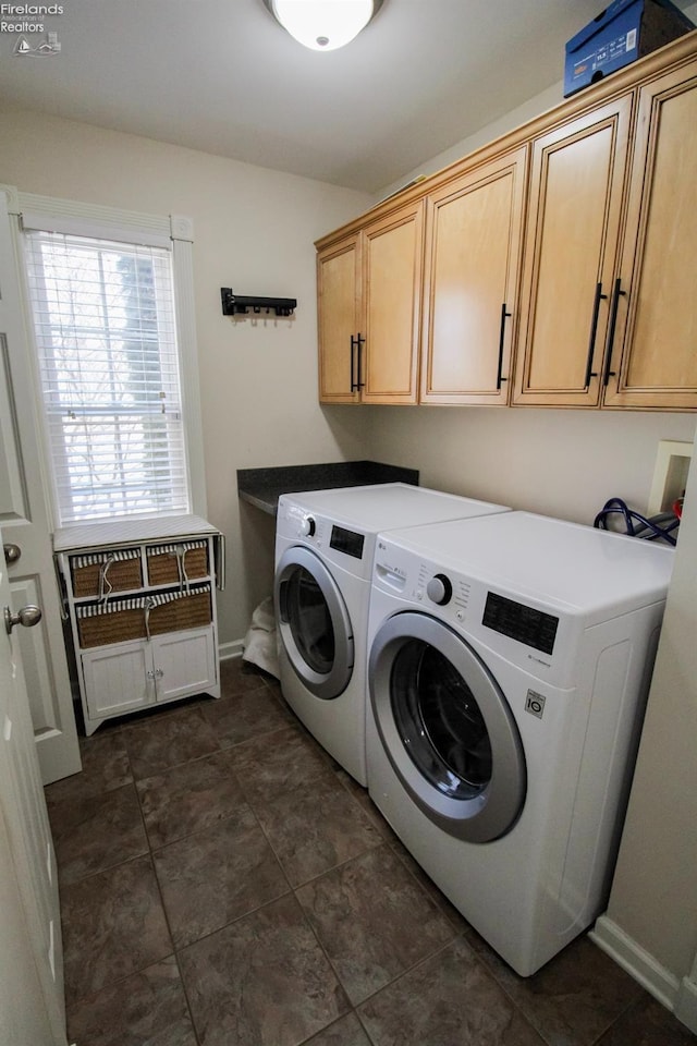 laundry area with washer and clothes dryer and cabinets