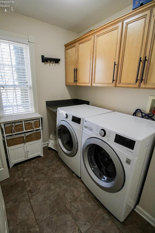 laundry room with cabinets and washer and dryer