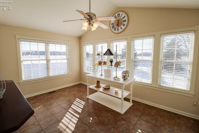 tiled dining space with vaulted ceiling, a healthy amount of sunlight, and ceiling fan