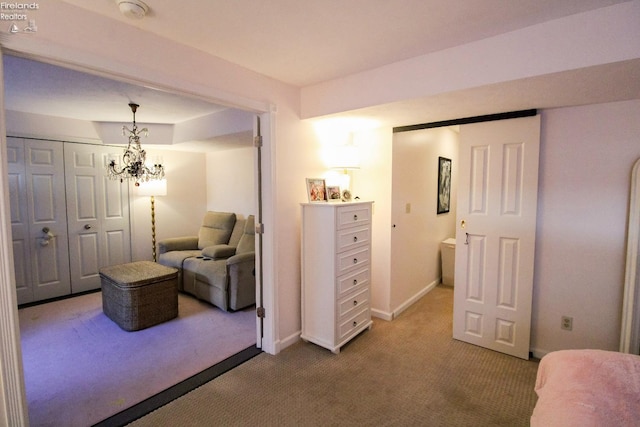 sitting room with carpet floors and a notable chandelier