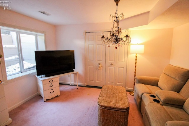 living room featuring a chandelier and carpet flooring