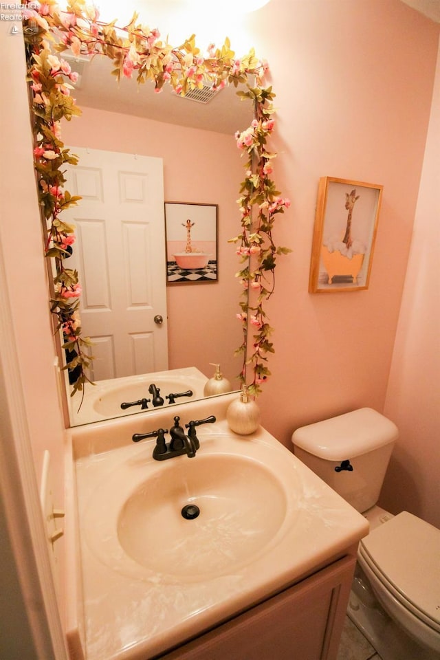 bathroom with tile patterned floors, toilet, and vanity