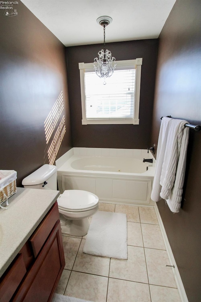 bathroom with tile patterned floors, vanity, a bathing tub, and a notable chandelier