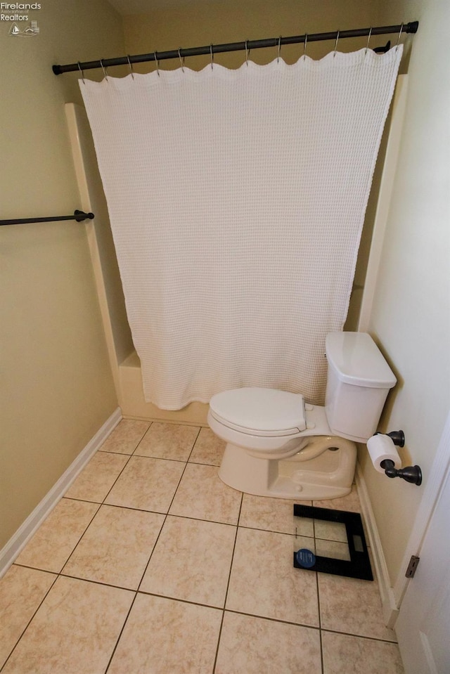 bathroom featuring shower / bath combo, toilet, and tile patterned floors